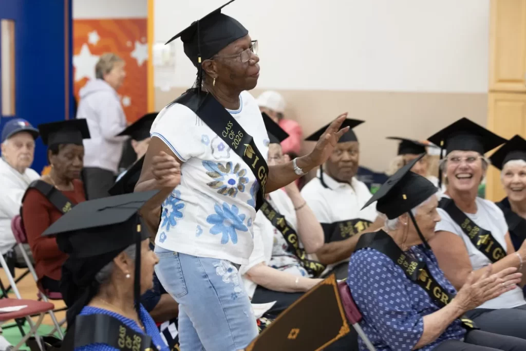 Gloria Sandy, a 78-year-old retired nurse, dances her way to the front of the room to accept her diploma. Tim Snow / Montreal Gazette